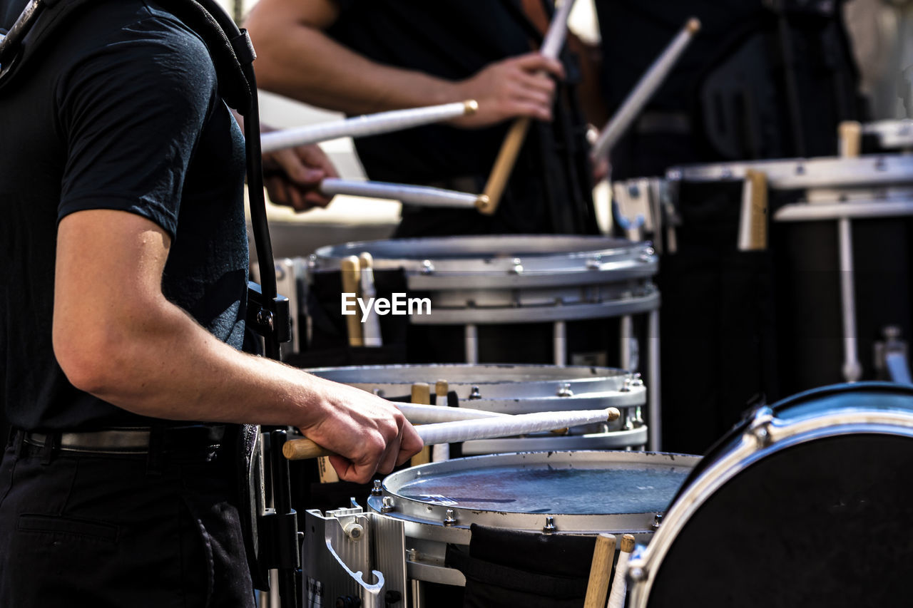 Section of a marching band drum line performing