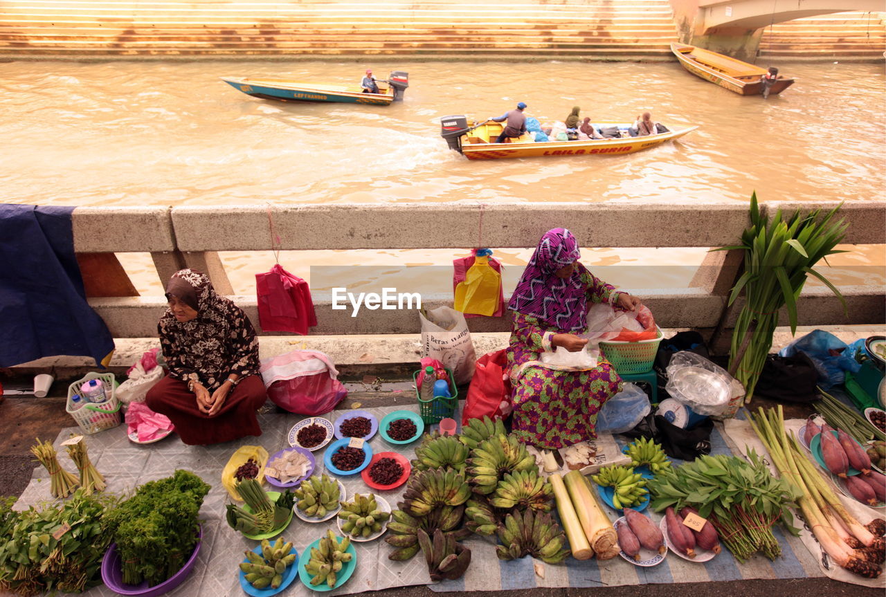 High angle view of women selling food on bridge over river