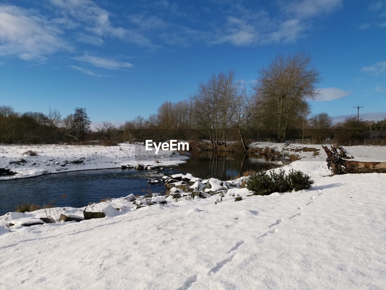 FROZEN RIVER AGAINST SKY DURING WINTER