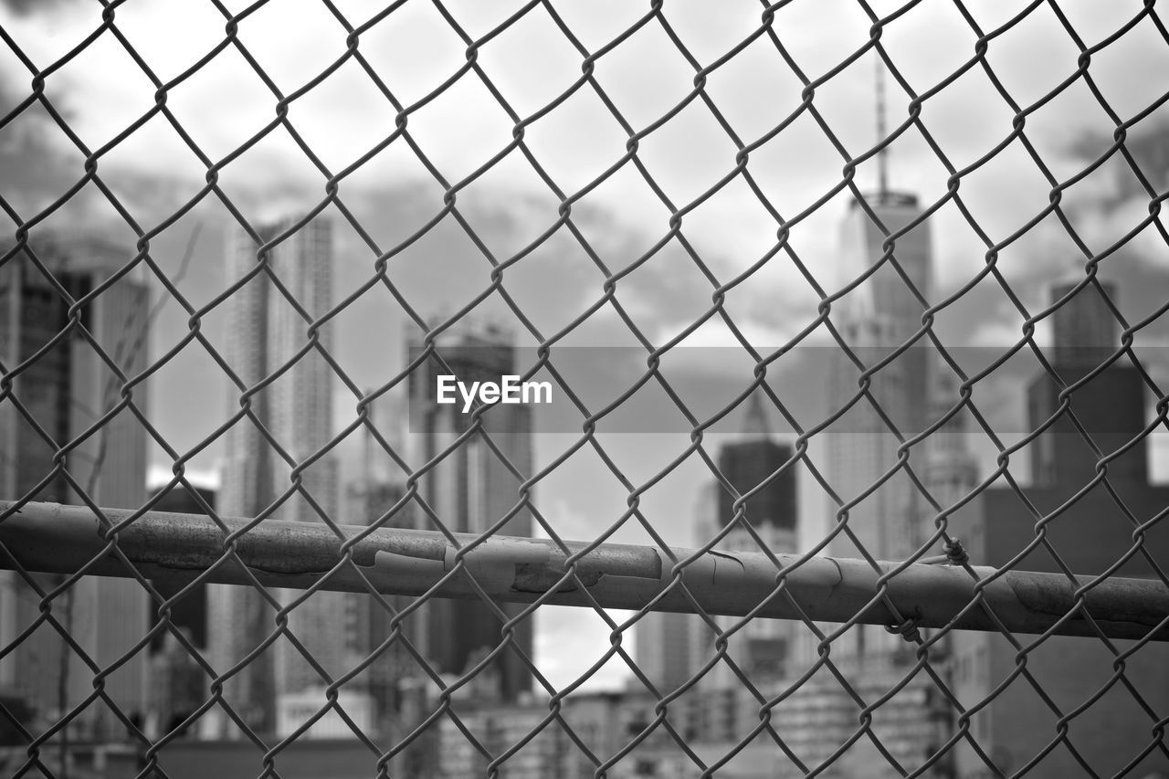 FULL FRAME SHOT OF CHAINLINK FENCE SEEN THROUGH METAL WIRE