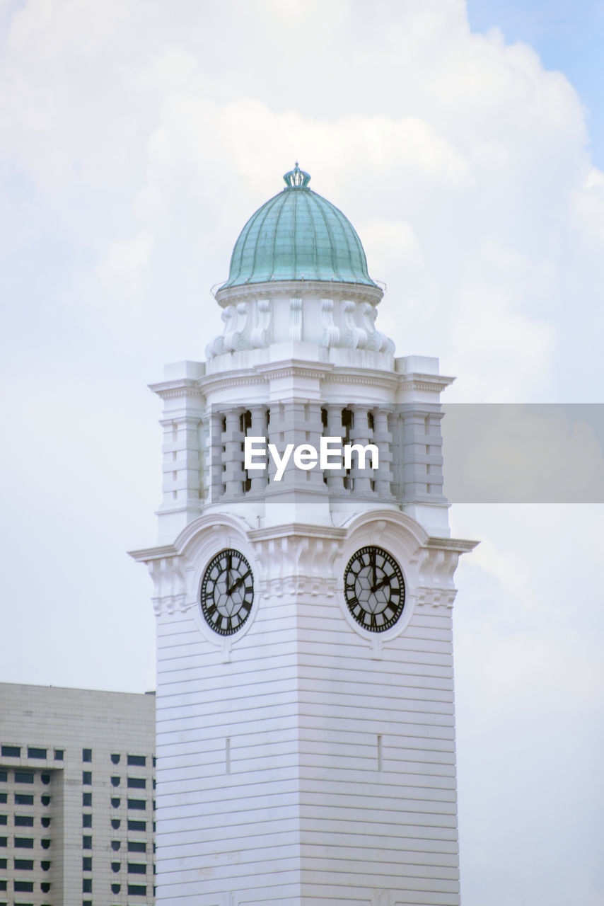 Low angle view of clock tower against sky in city