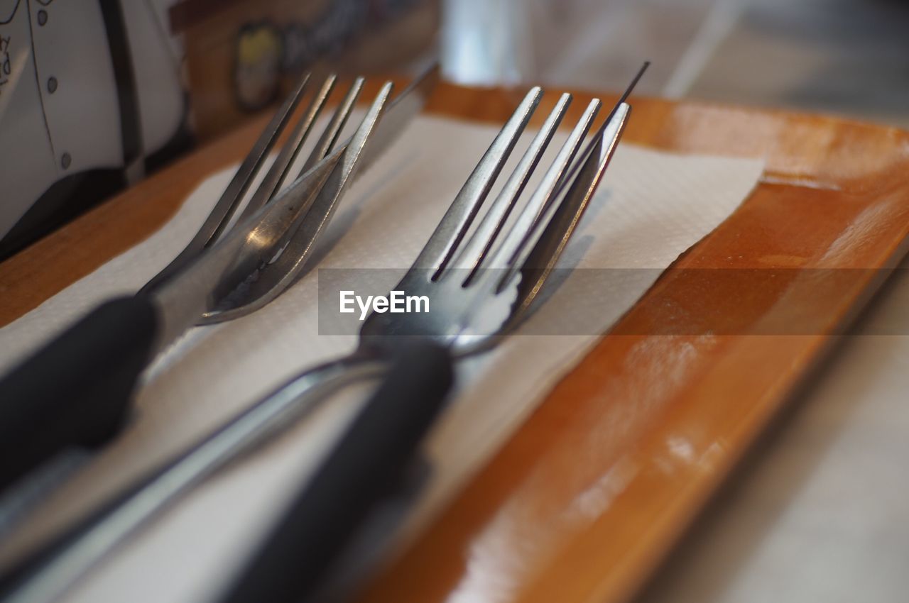 Close-up of eating utensils in tray