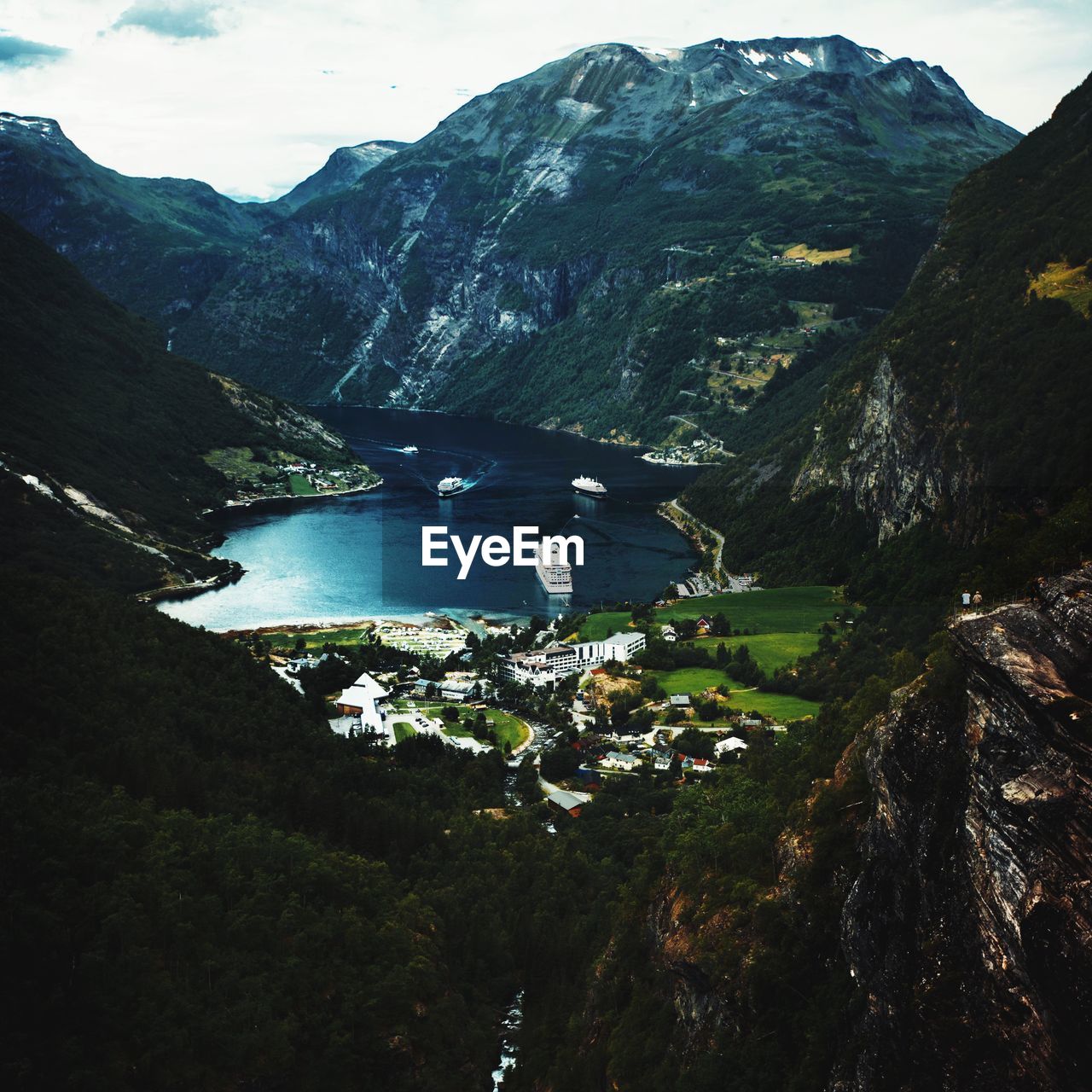 High angle view of lake and mountains against sky