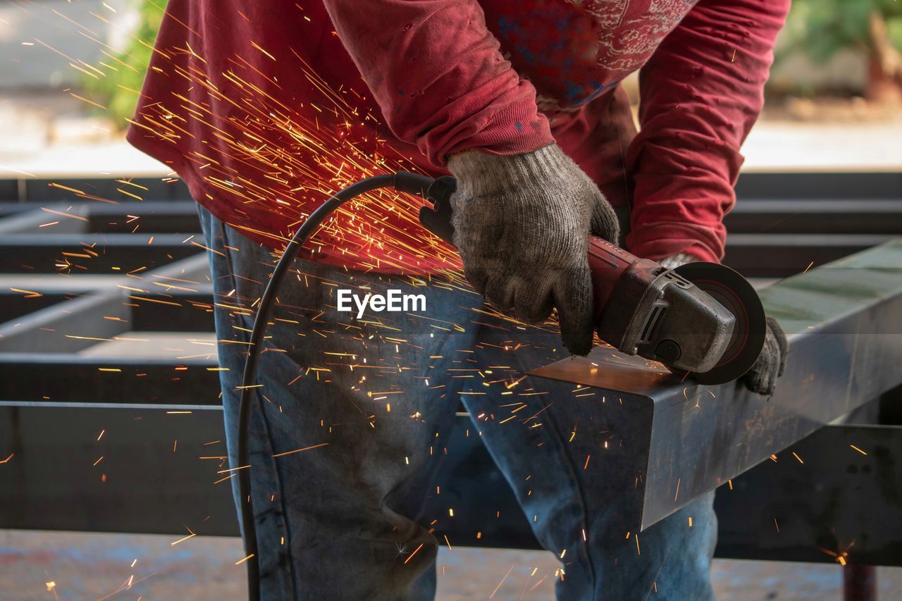 MIDSECTION OF MAN WORKING AT NIGHT