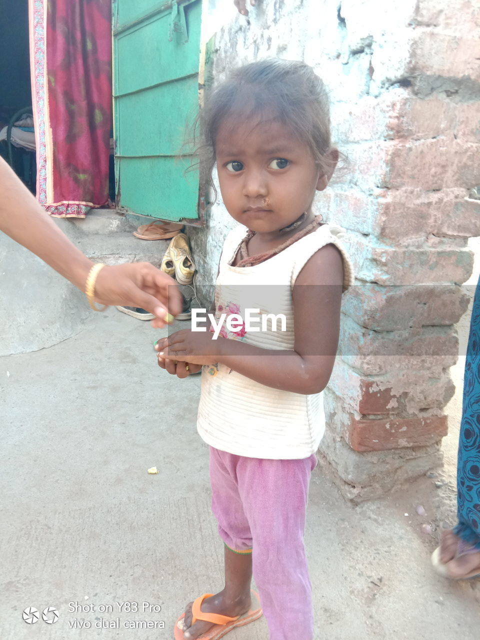 PORTRAIT OF CUTE GIRL HOLDING CAMERA