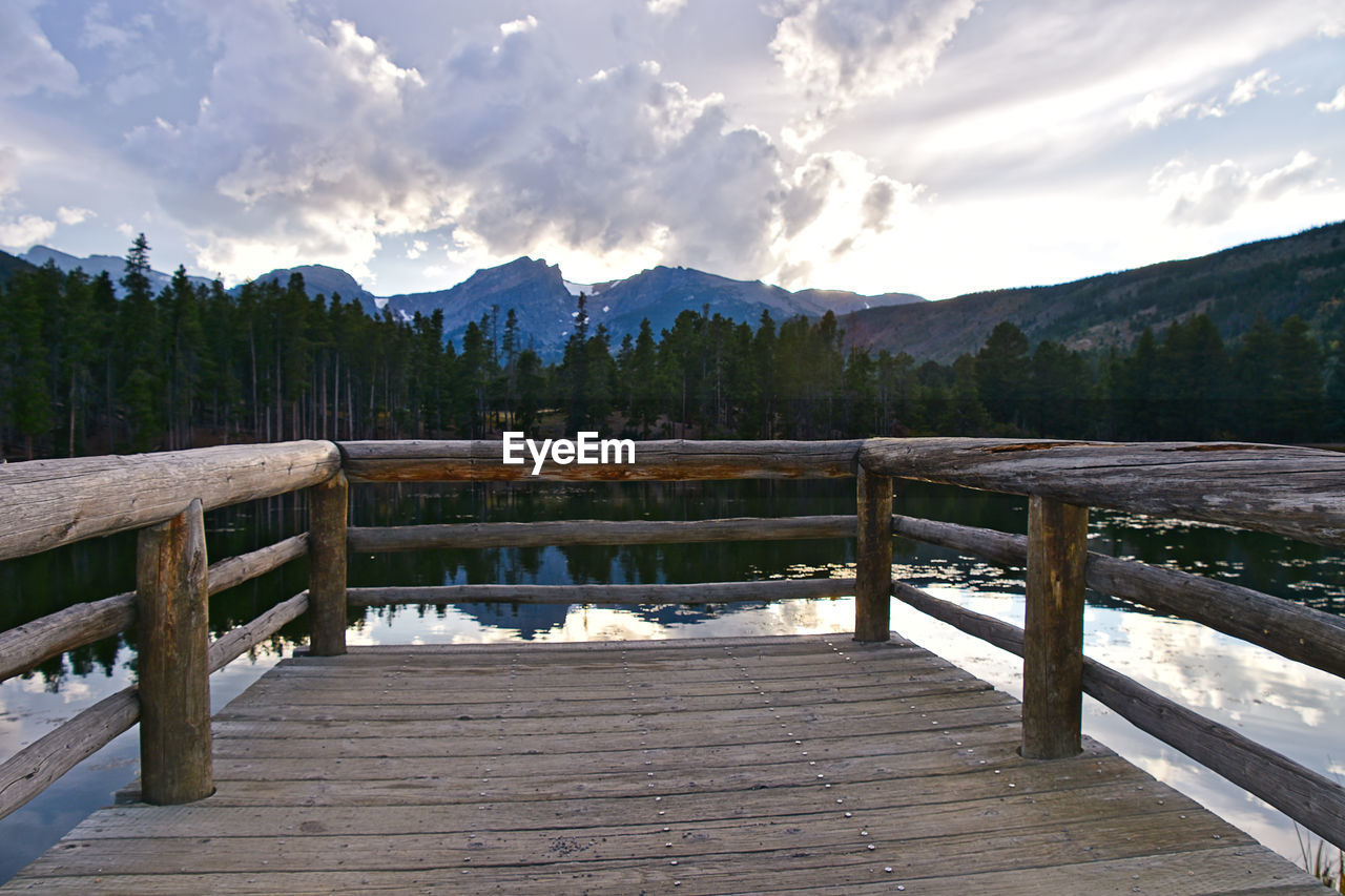 Pier over lake against sky