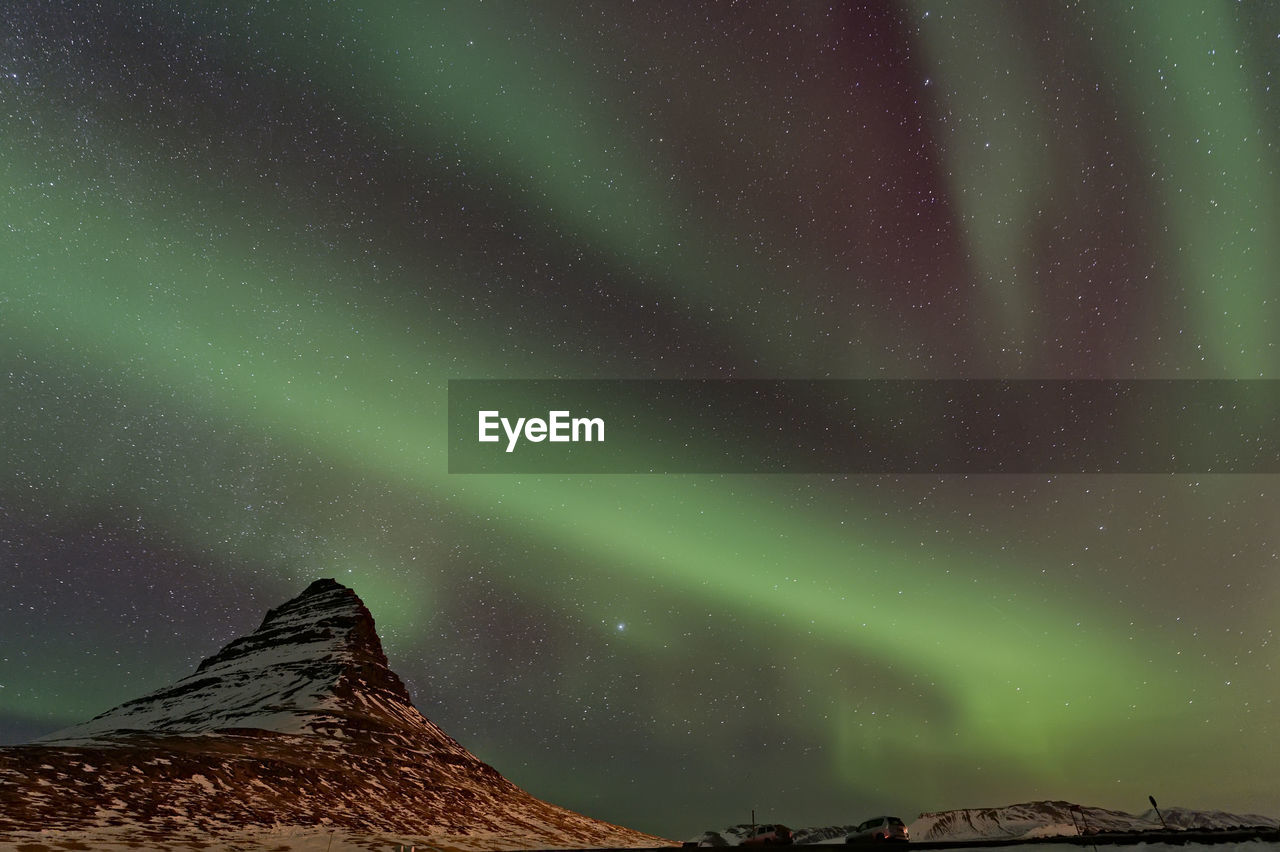 Low angle view of aurora borealis at night during winter