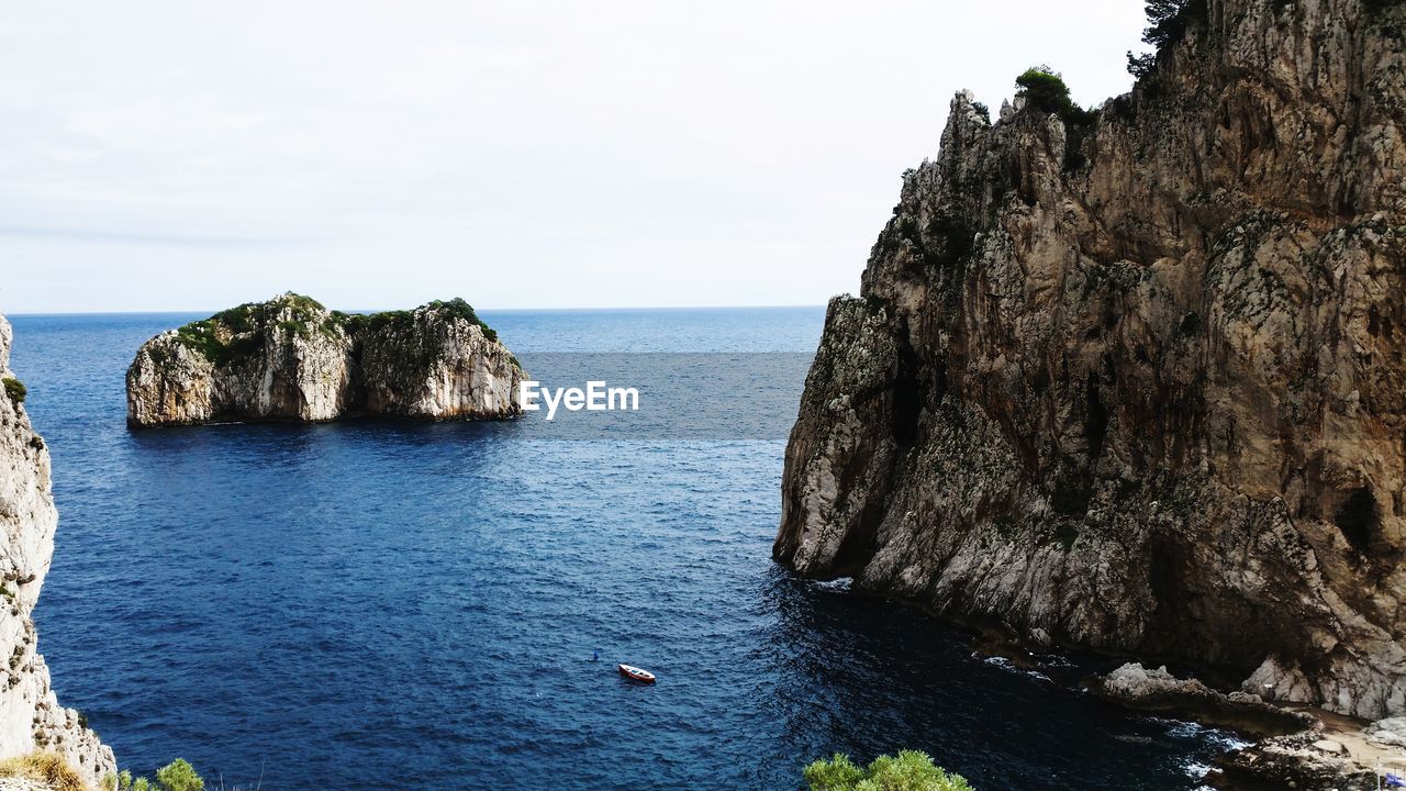 Capri - rock formation in sea against sky