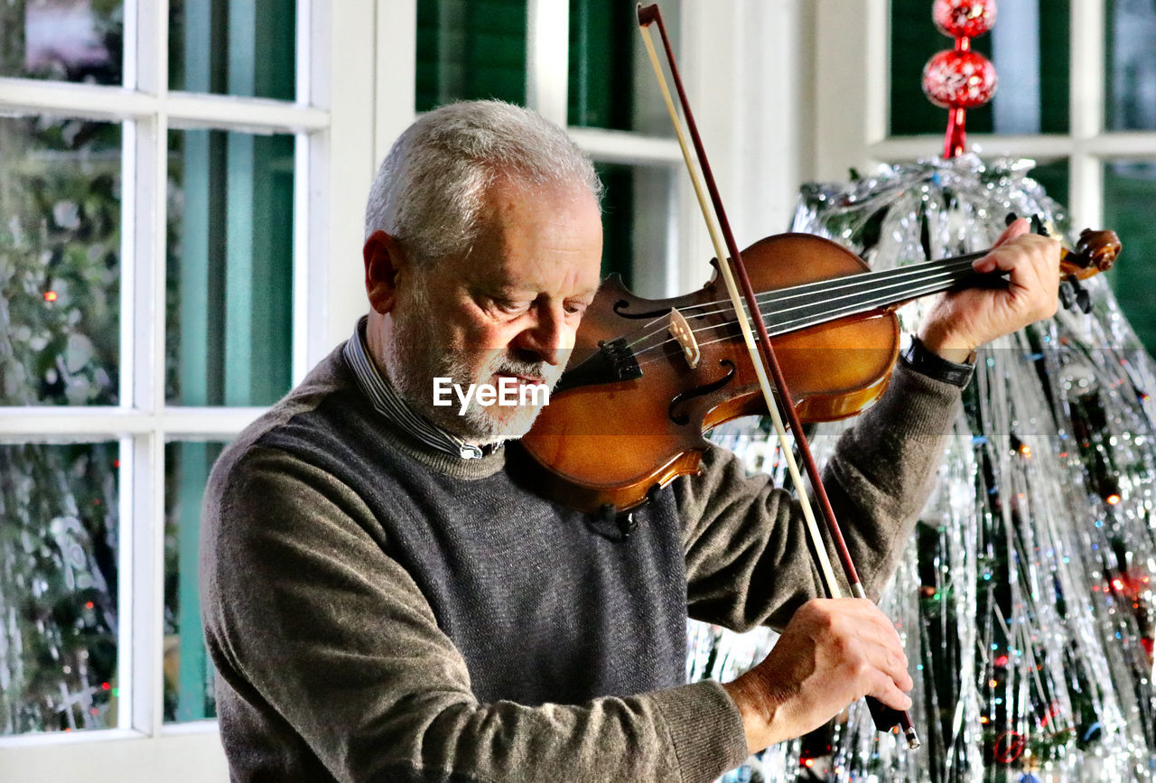 Senior man playing violin