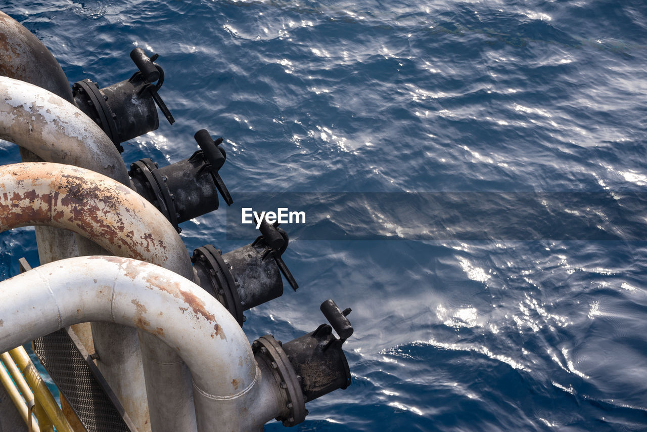 High angle view of pipes over sea