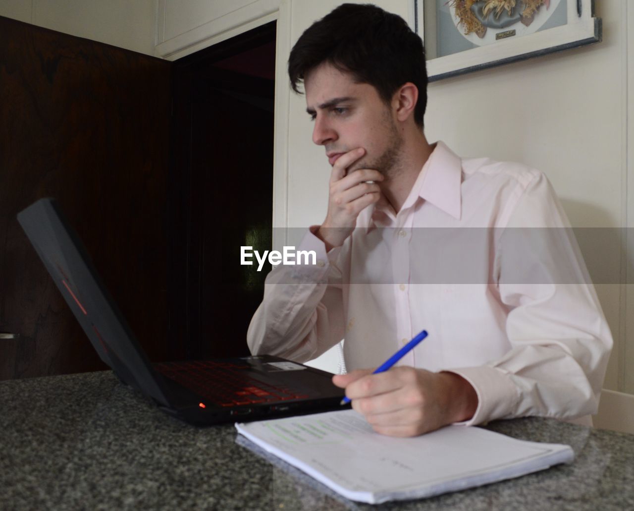 Young man using laptop at home