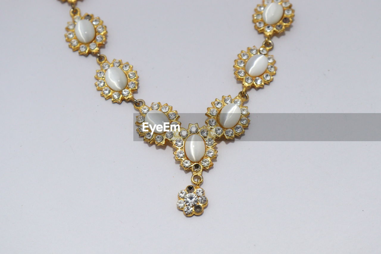 Close-up of decoration traditional indian wedding jewellery necklace with white diamond.