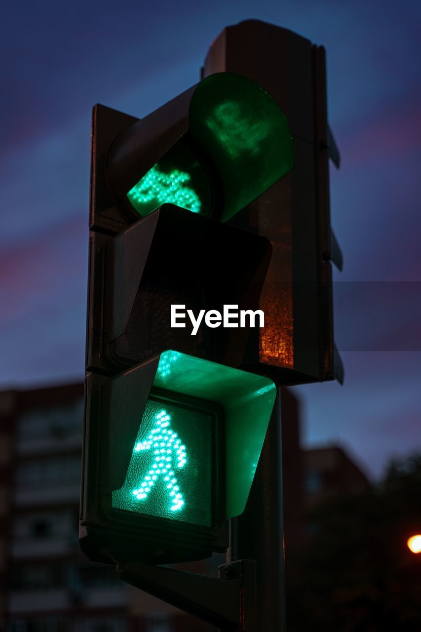 Close-up of road signal. green light. walk now. bicycle sign. semaphore. traffic light.