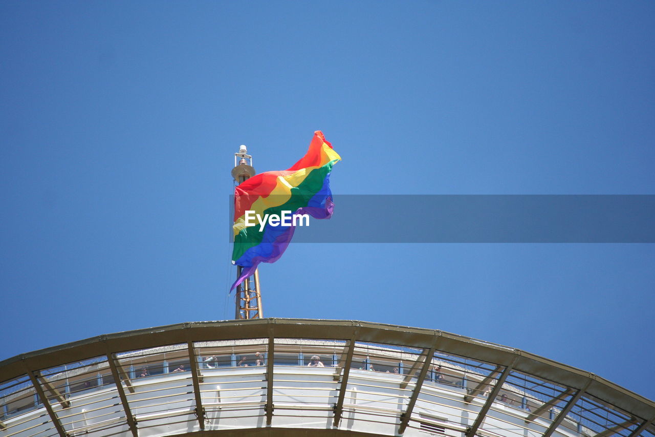 LOW ANGLE VIEW OF COLORFUL BUILDING AGAINST BLUE SKY