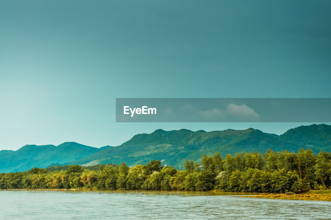 Scenic view of mountains against blue sky