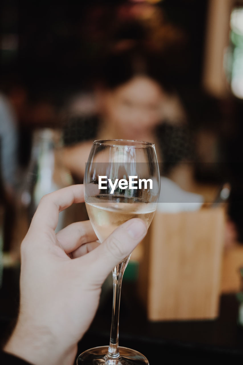 Close-up of hand holding wineglass