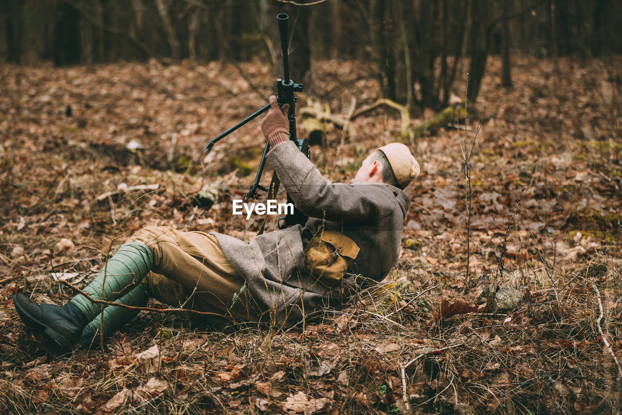 MAN LYING DOWN ON FIELD