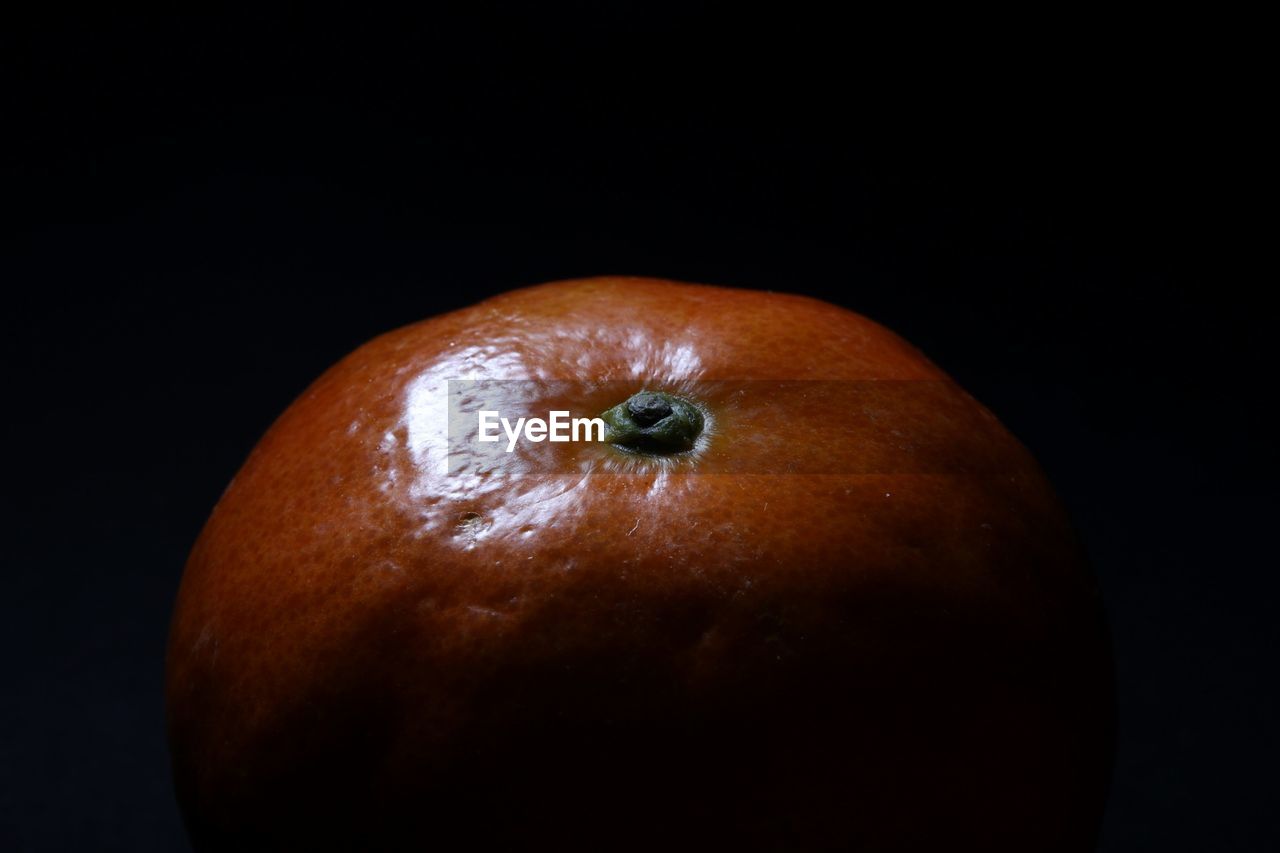 CLOSE-UP OF FRUIT AGAINST BLACK BACKGROUND