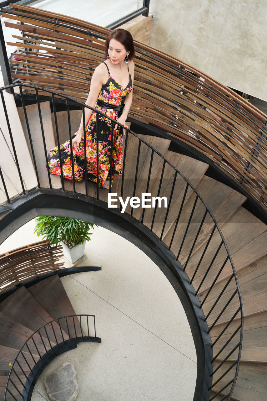 Portrait of woman standing on staircase