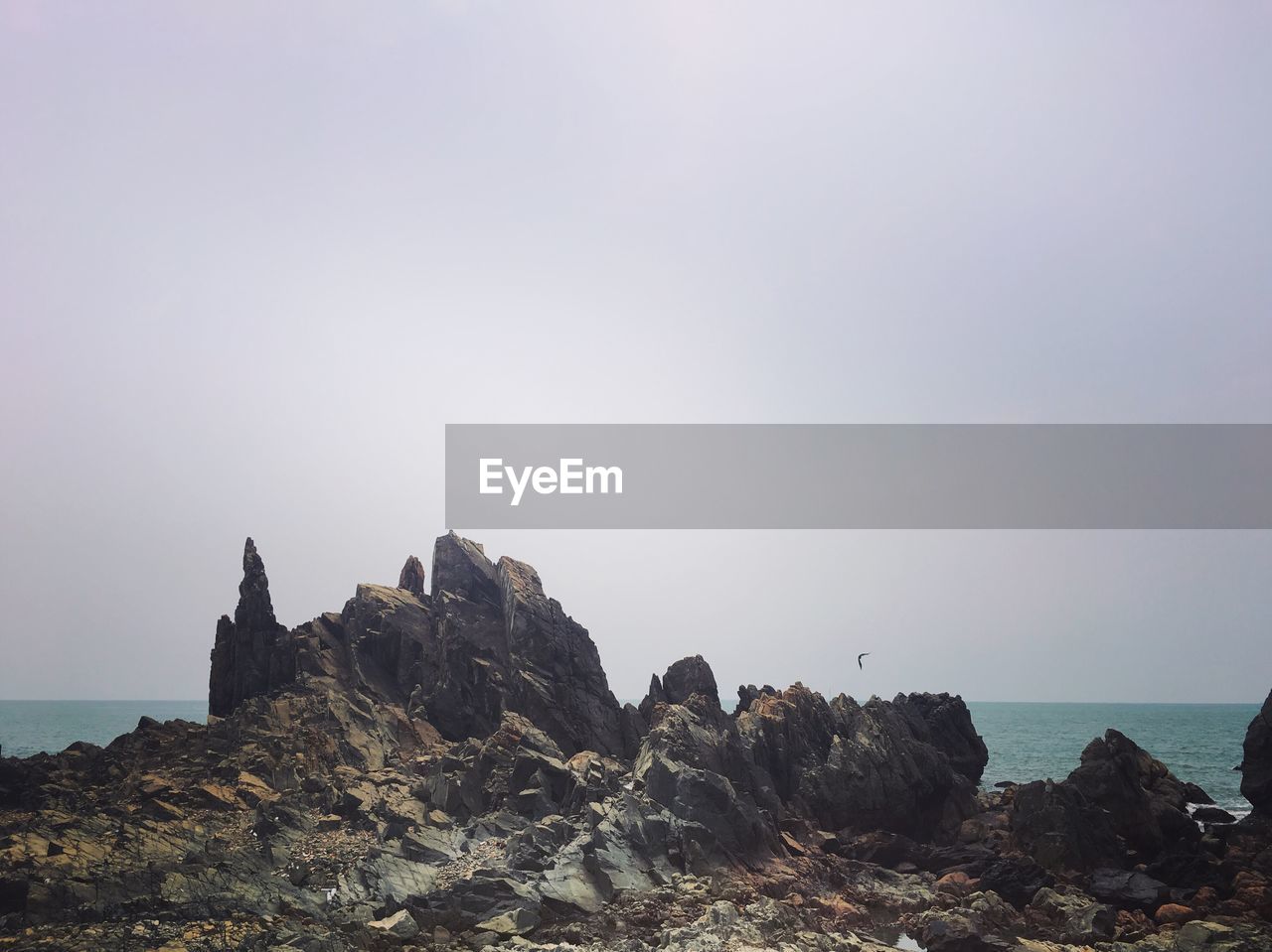 Scenic view of rocks against clear sky