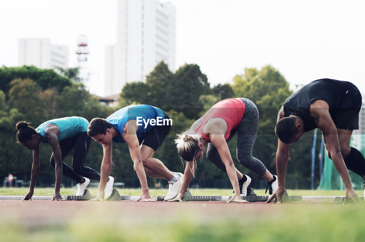 Runners poised at starting blocks on track