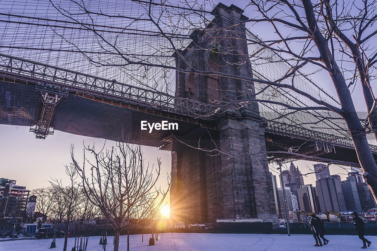 Low angle view of brooklyn bridge against sky during sunset