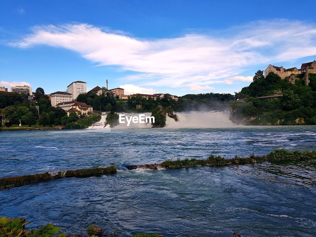 Scenic view of waterfall against sky