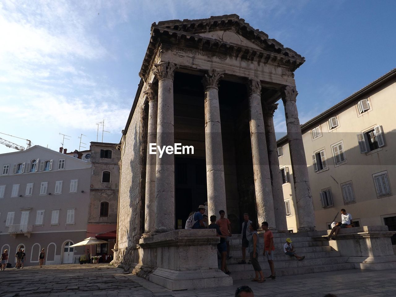 People at historic building in city