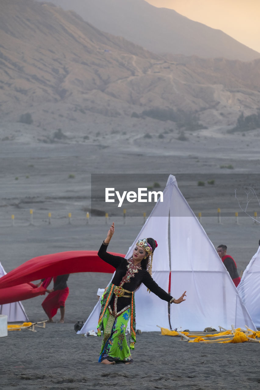 Woman in traditional clothing dancing on outdoors