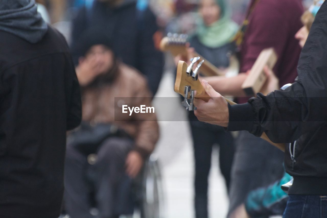 Musician playing guitar on street