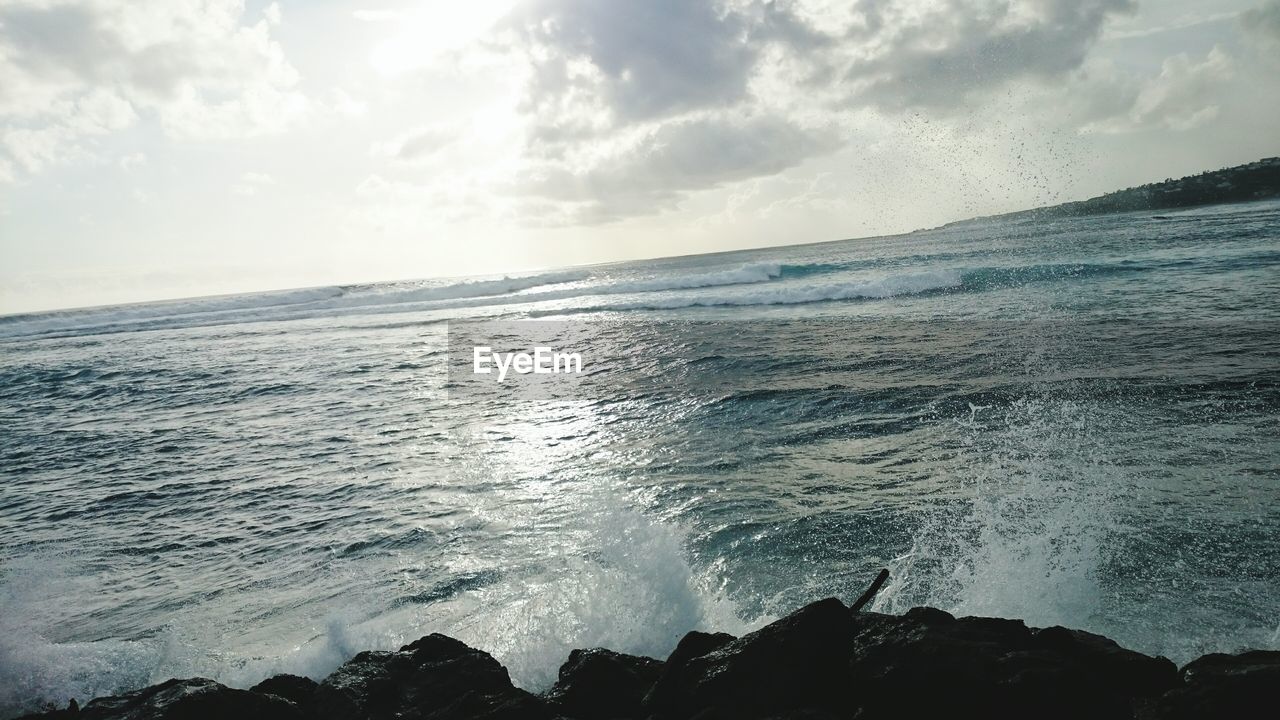 VIEW OF SEA AGAINST CLOUDY SKY