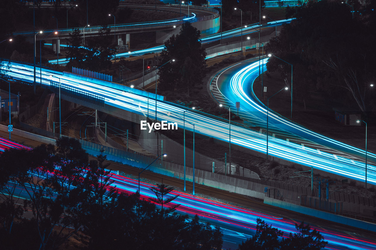 HIGH ANGLE VIEW OF LIGHT TRAILS ON ROAD