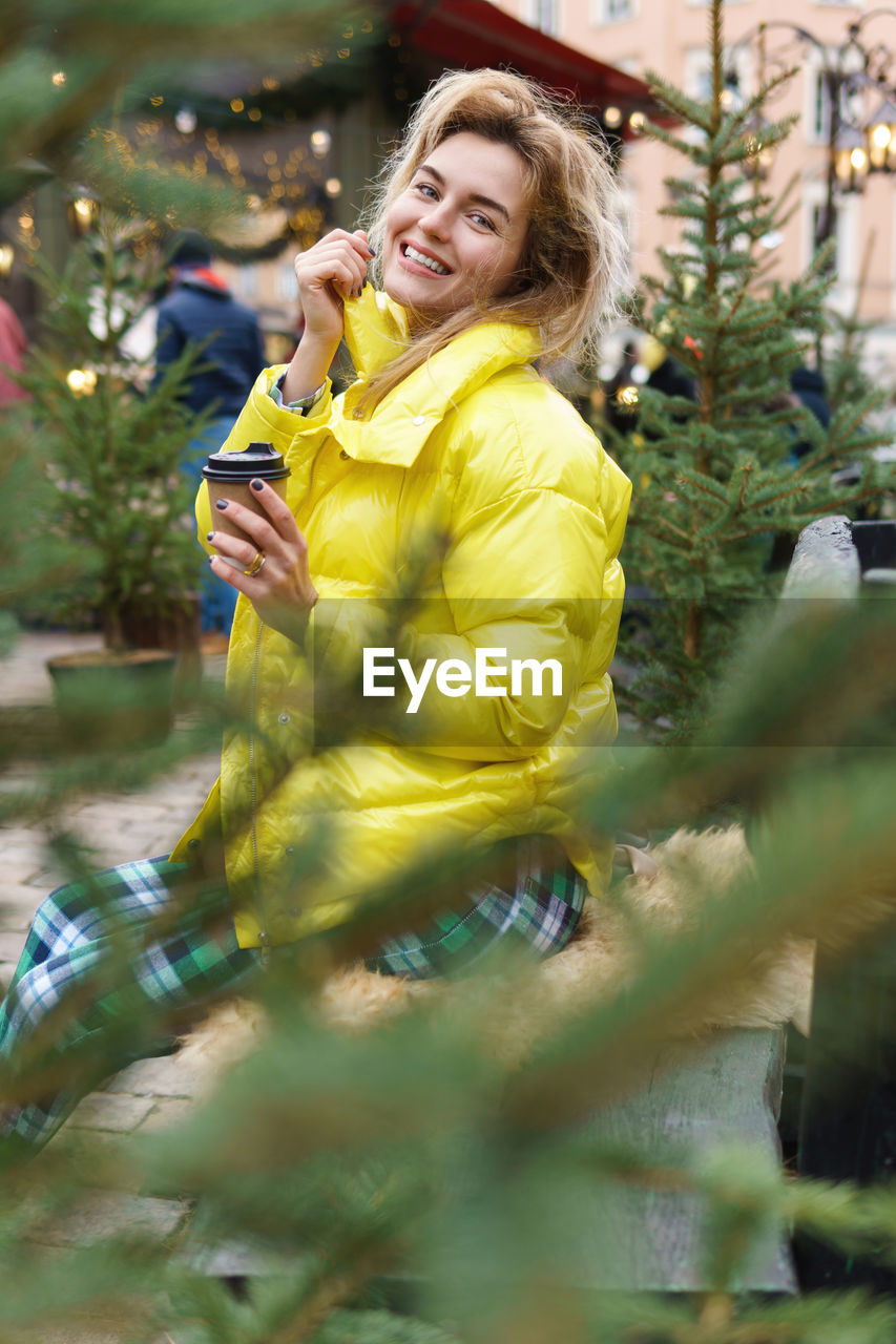 portrait of young woman with eyes closed standing in park