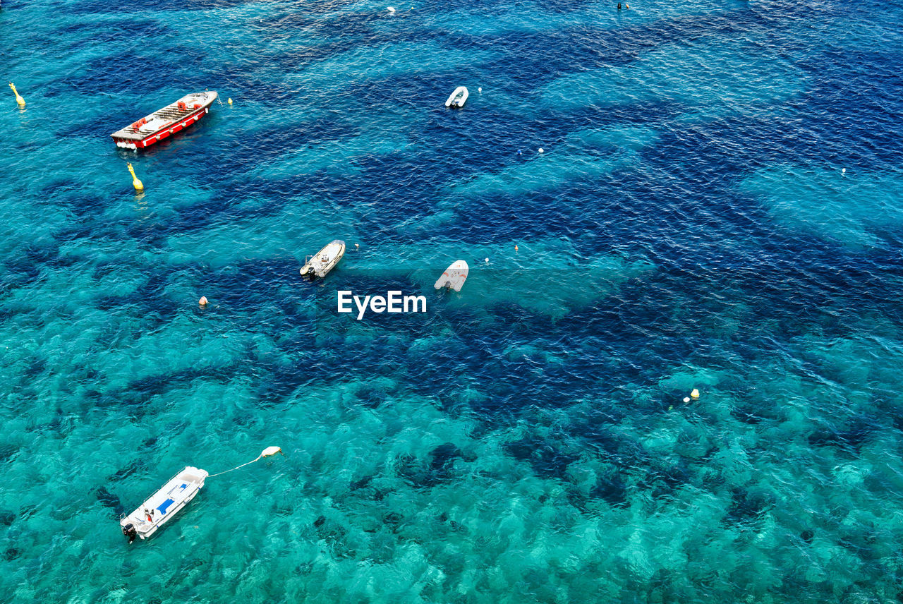 Boats on the seashore in a crystalline sea