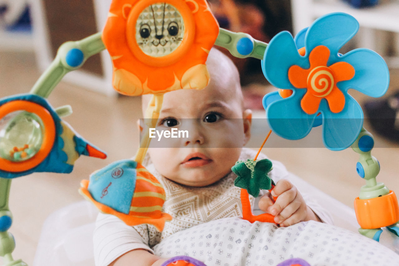 Sweet baby playing with colorful toys