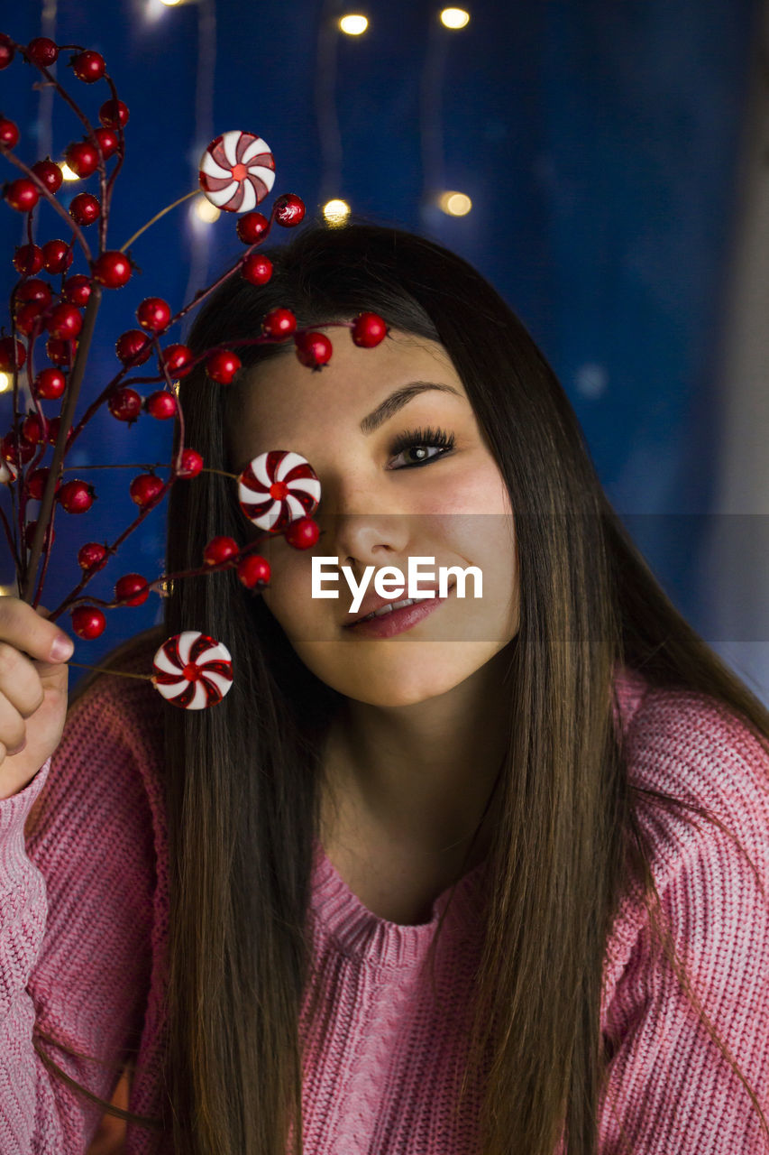 portrait of young woman with christmas tree