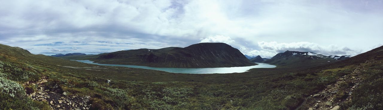 SCENIC VIEW OF MOUNTAINS AND CLOUDY SKY