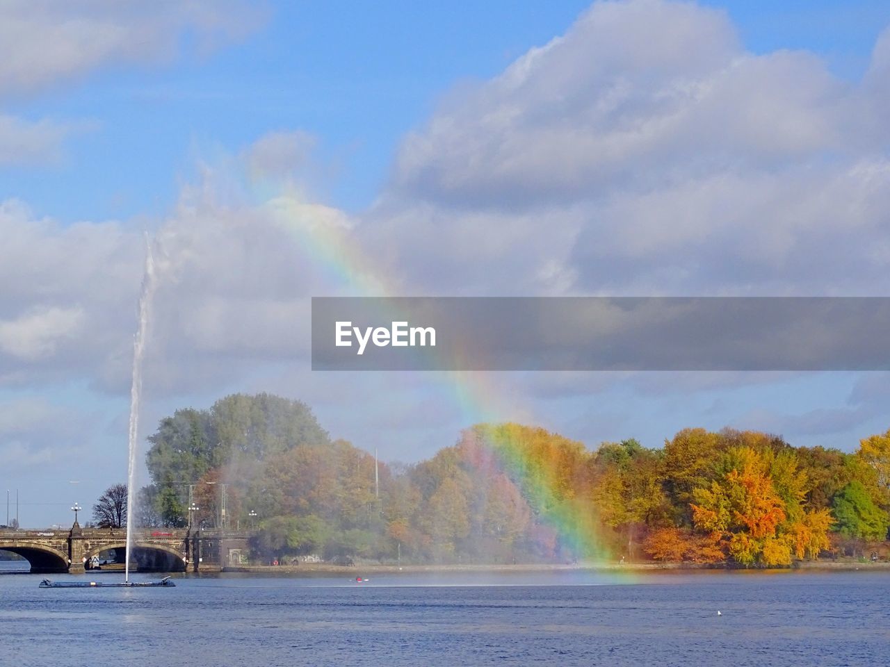 Panoramic view of rainbow over trees against sky
