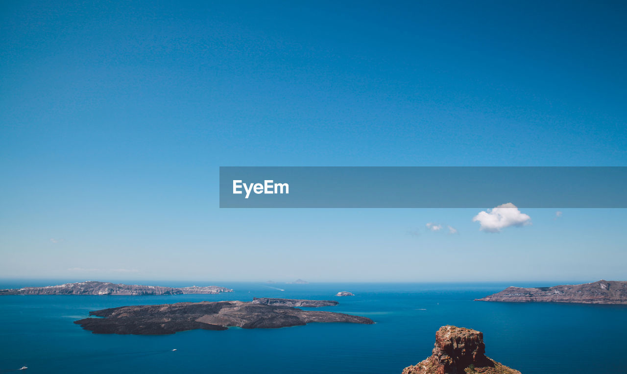 Scenic view of blue sea against clear sky on sunny day