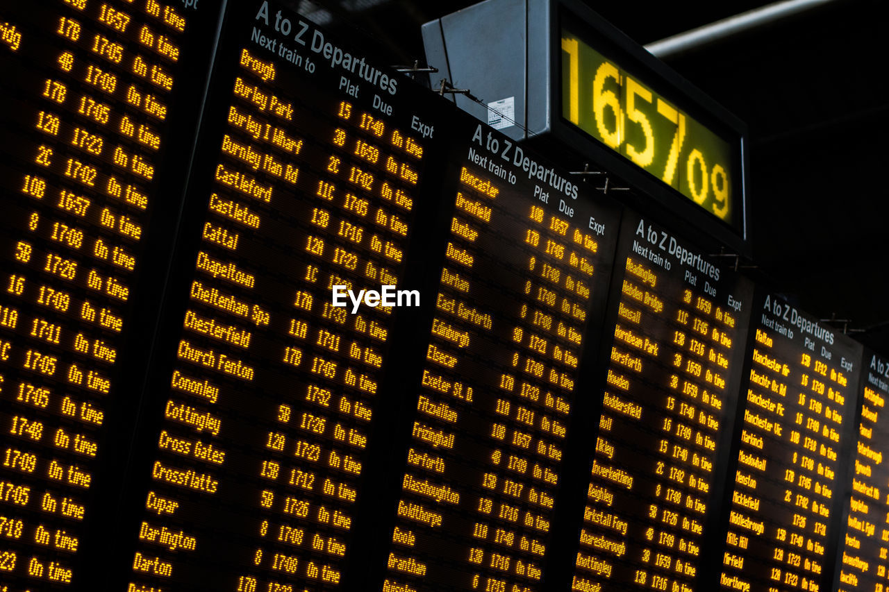 LOW ANGLE VIEW OF ILLUMINATED YELLOW TEXT AT NIGHT