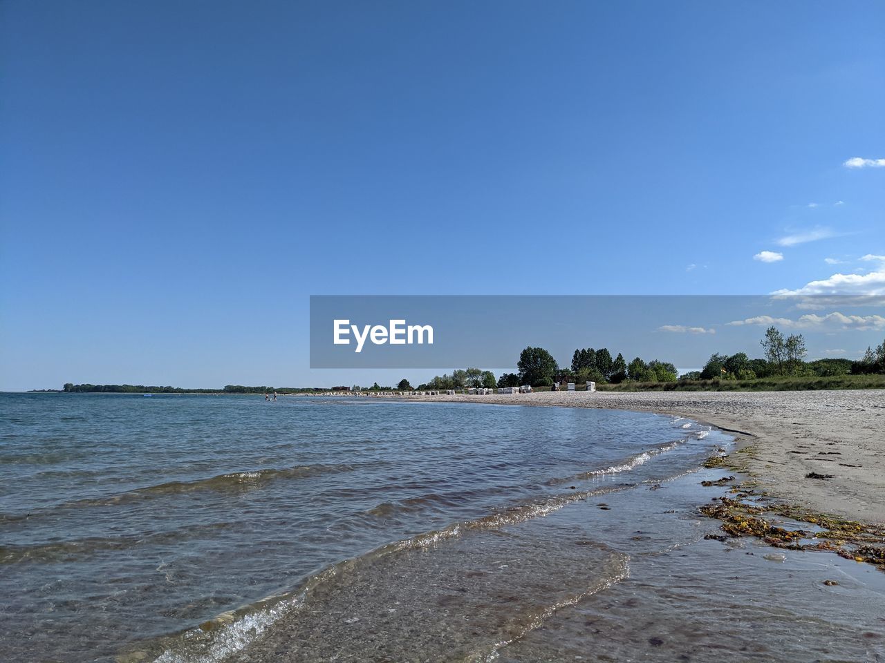 SCENIC VIEW OF BEACH AGAINST BLUE SKY