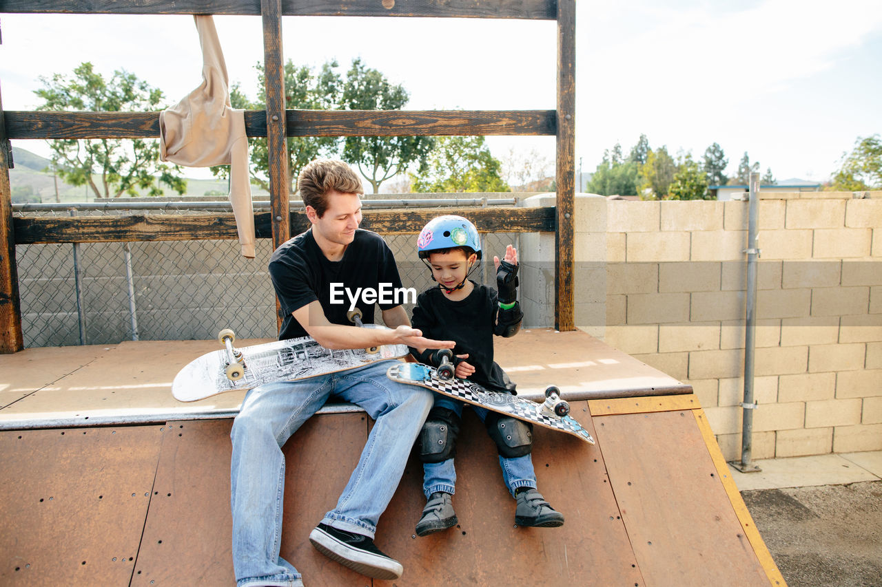 Skateboarding instructor and student high five