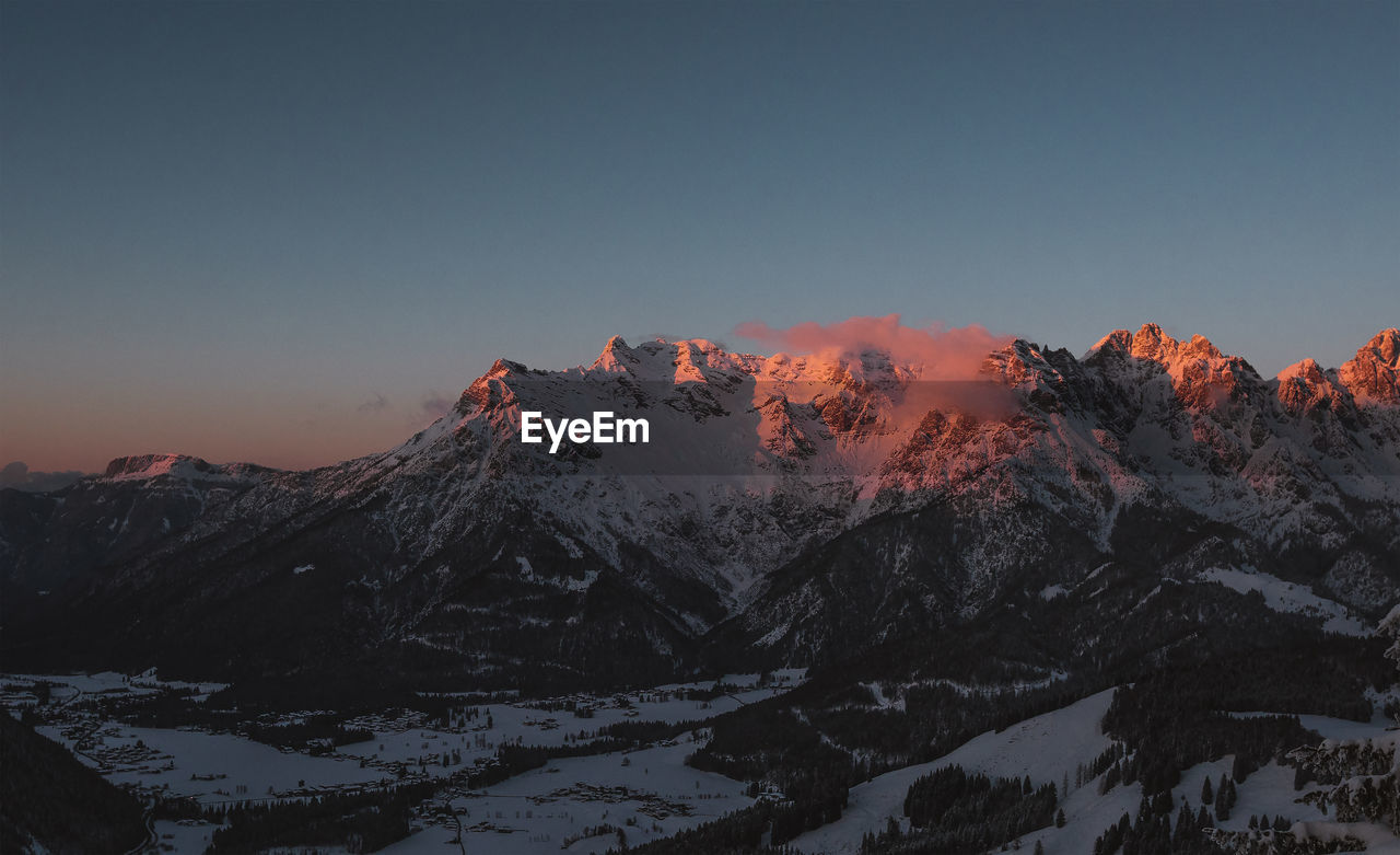 Scenic view of snowcapped mountains against clear sky during winter