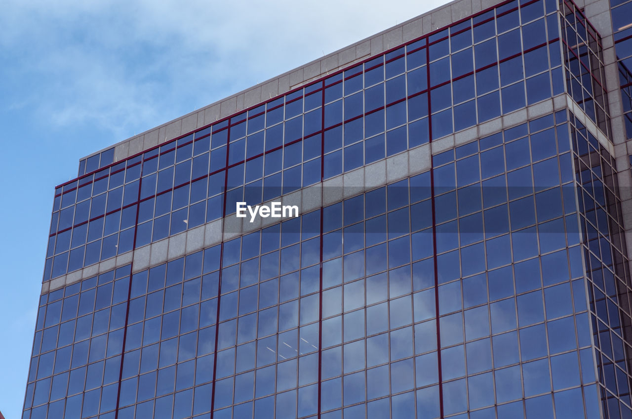 Low angle view of building against cloudy sky