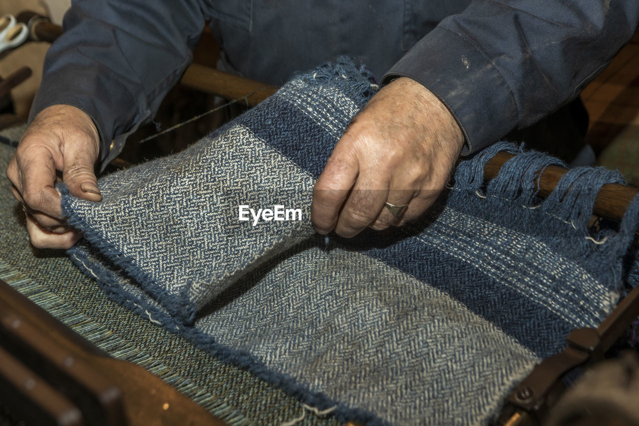 HIGH ANGLE VIEW OF MAN WORKING ON MESSY