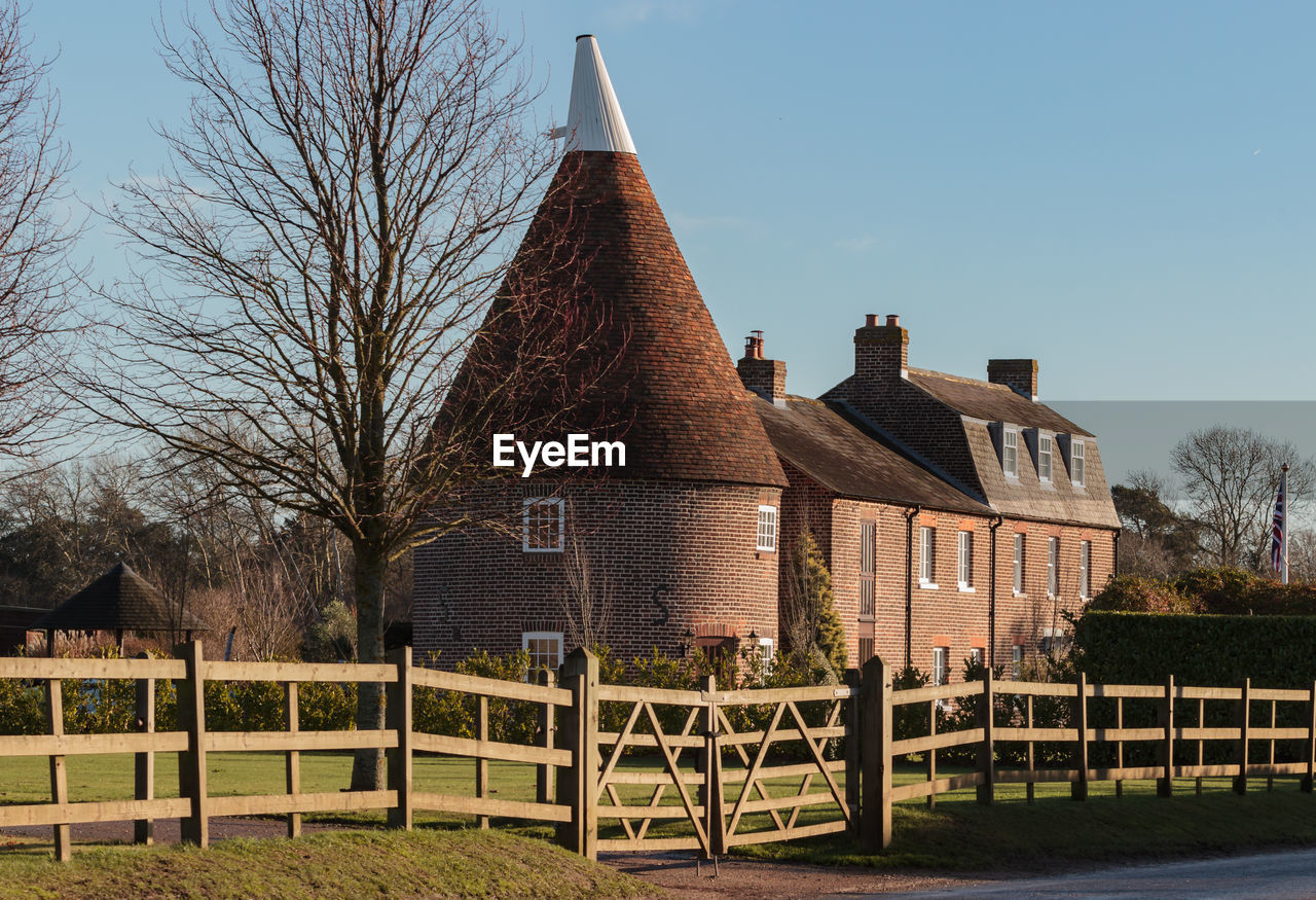 BUILT STRUCTURE ON FIELD AGAINST CLEAR SKY