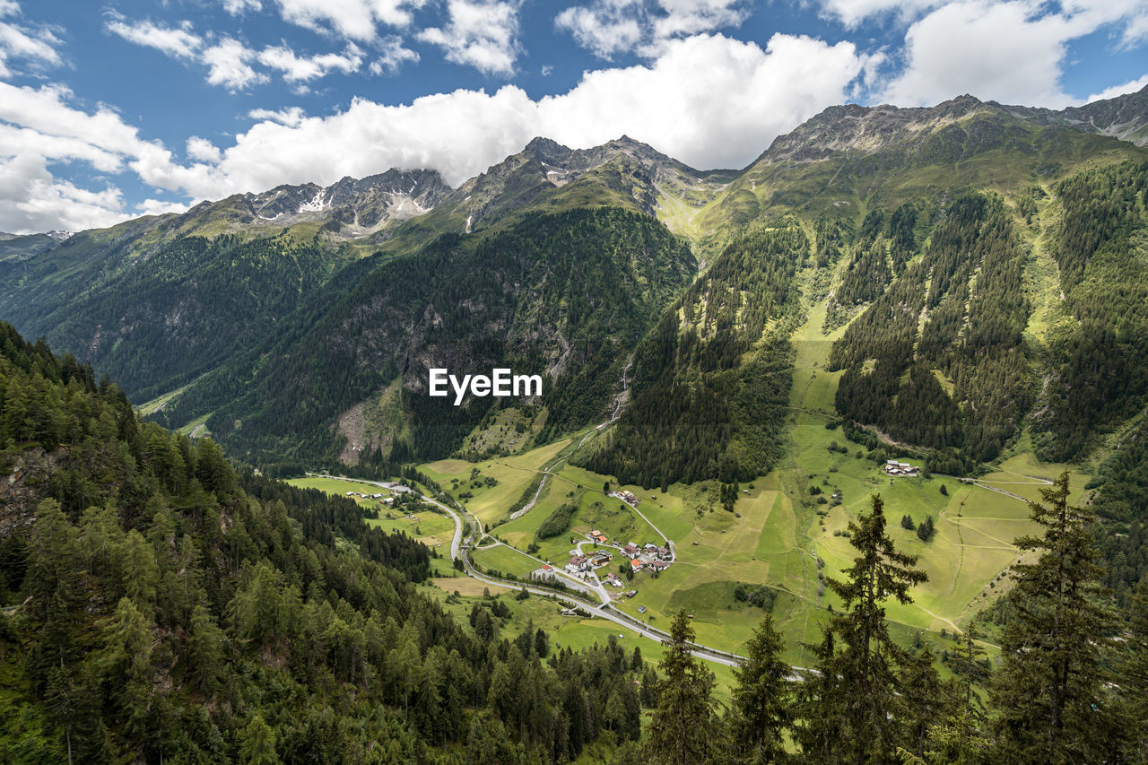 Scenic view of valley and mountains against sky