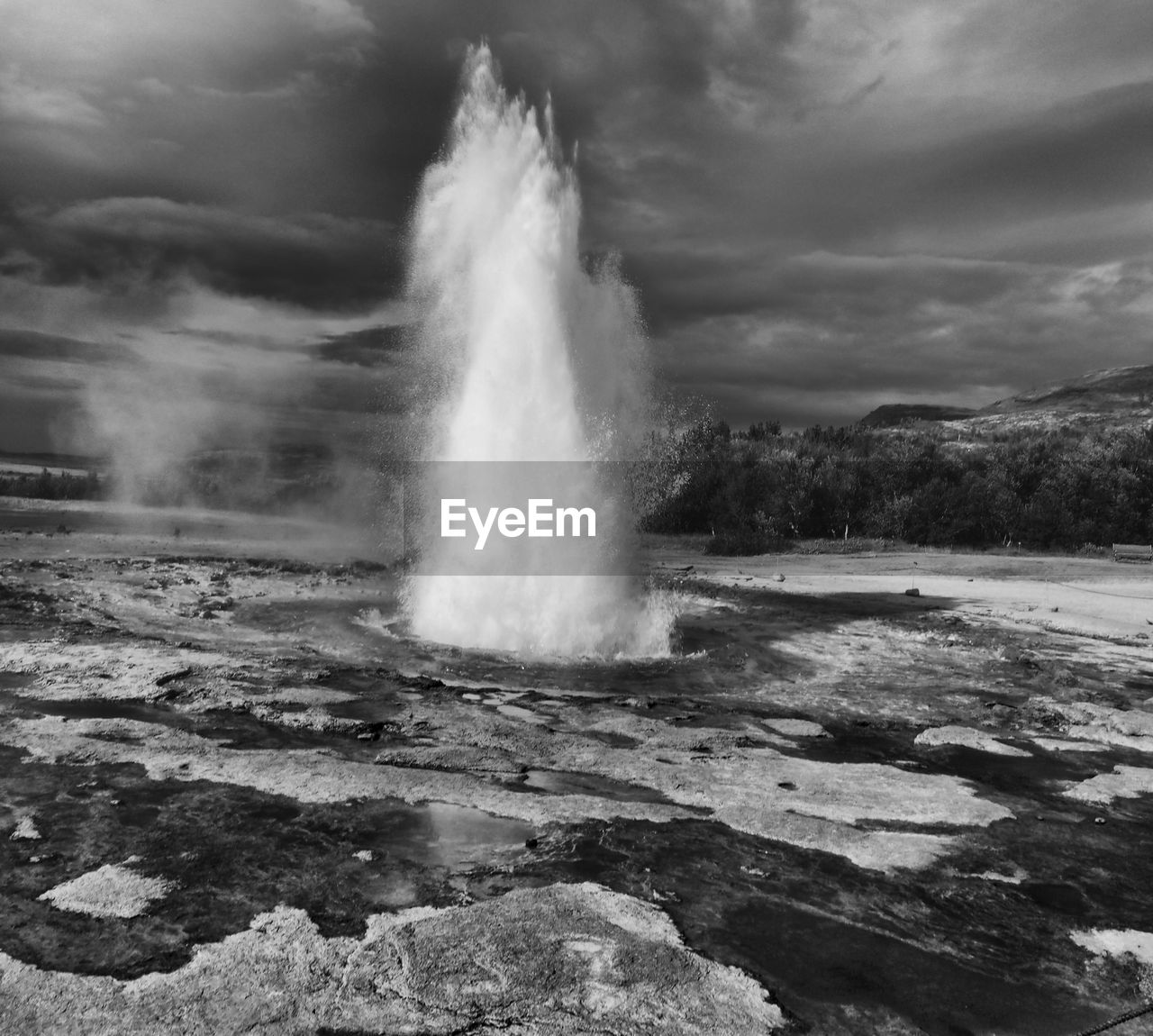 Eruption of strokkur geyser against clouds