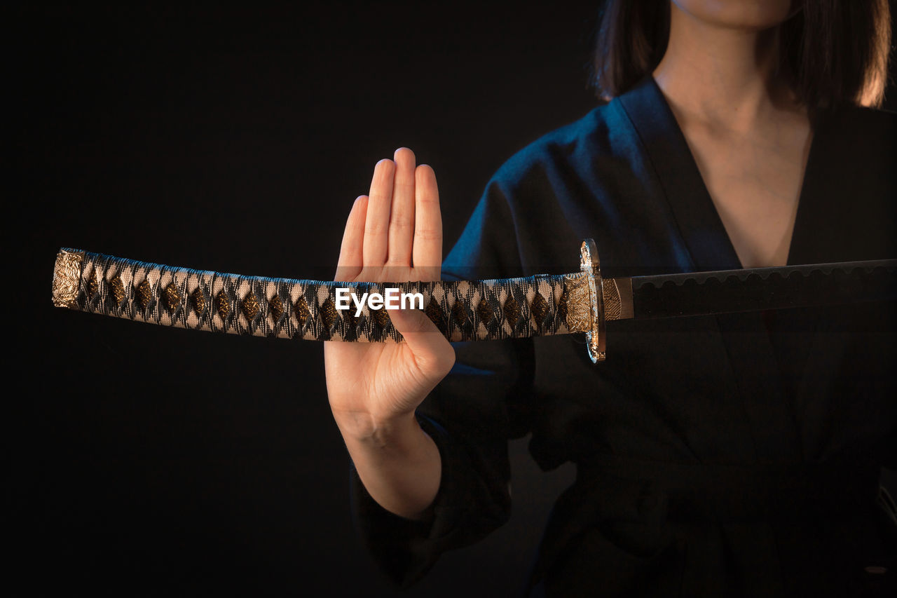 midsection of woman holding trophy