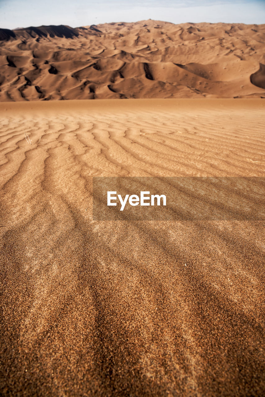 The formation of sands in dasht e lut or sahara desert with waved sand pattern on sand dune. 